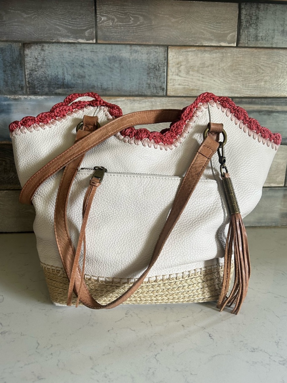 The Sak White Leather Shoulder Bag with Pink Embroidered Trim and Tan Braiding